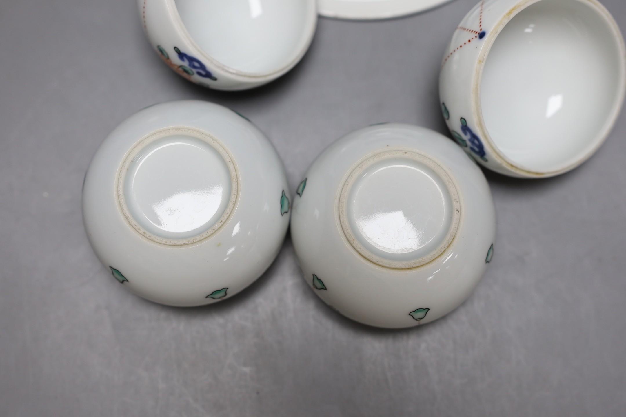 A pair of Japanese Nabesima style jars and covers and a similar footed dish, together with a Japanese Satsuma bowl, 11cm diameter and two plates (5)